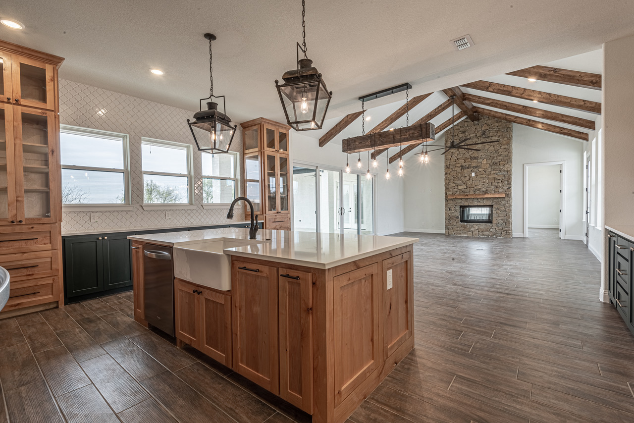 Custom built Farmhouse interior kitchen located in Weatherford Texas with wood floors and wooden cabinets